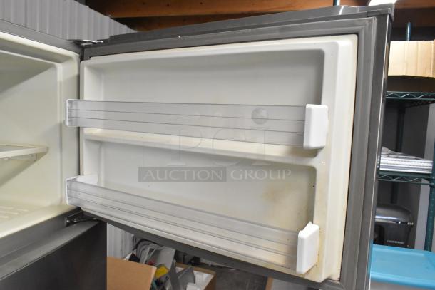 2016 Whirlpool WRT511SZDM00 stainless steel cooler and freezer, open door, showing interior shelves, in used condition.