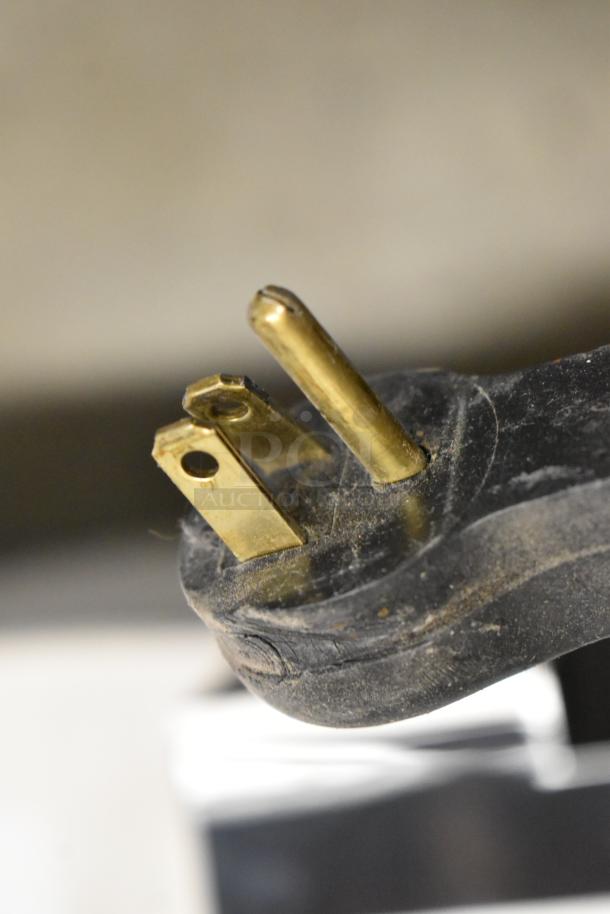 Close-up of a three-prong plug from an Oasis 504324 PG8AC Versacooler II Drinking Fountain, showing slight surface dust.