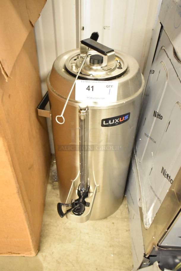 Brand new Fetco Luxus TPD-30, 3-gallon stainless steel coffee dispenser. Minor scratches and dents, model label visible.