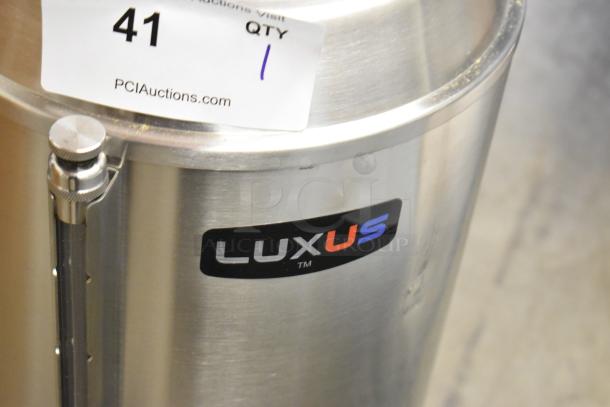 BRAND NEW Fetco Luxus TPD-30, 3-gallon stainless steel coffee dispenser with minor cosmetic scratches.