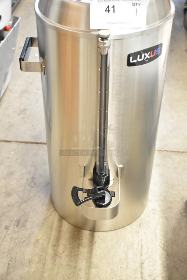 Stainless steel Fetco Luxus TPD-30, 3-gallon coffee dispenser, brand new with minor scratches, featuring a front tap and handle.