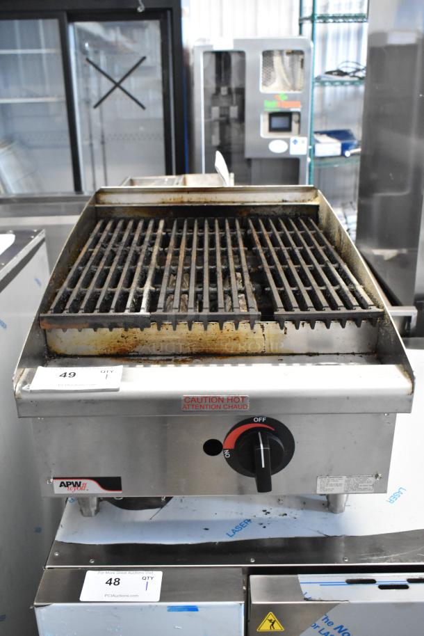 APW Wyott stainless steel gas charbroiler grill, used condition, with heat caution label and adjustable knob.