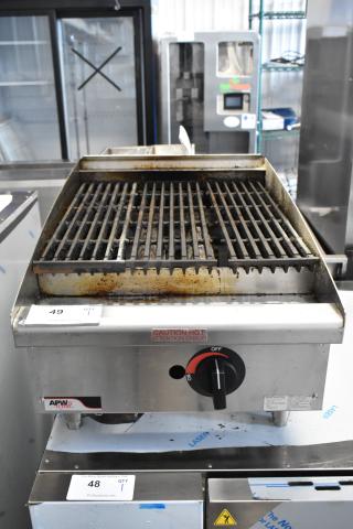 APW Wyott stainless steel gas charbroiler grill, used condition, with heat caution label and adjustable knob.