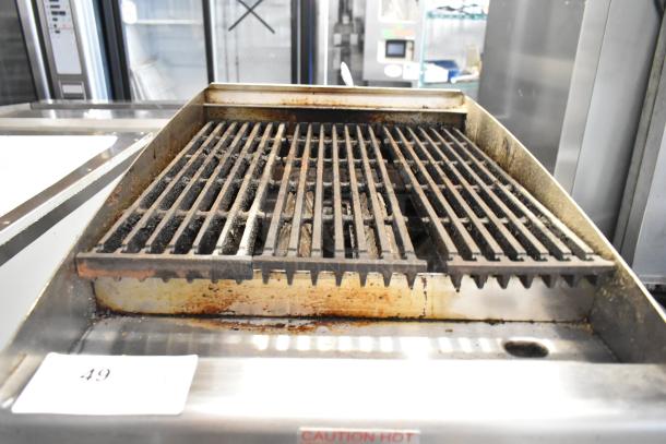 APW Wyott stainless steel commercial countertop gas charbroiler grill, used, with visible signs of wear on grates.