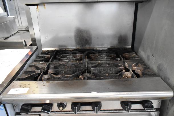 American Range AR-6, stainless steel, 6-burner gas range with oven, salamander cheese melter, and backsplash, used condition.