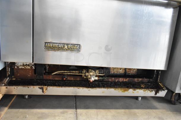 American Range AR-6 stainless steel commercial gas range with 6 burners, oven, salamander, and visible wear. Model: AR-6.