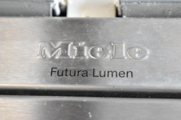 Miele G 6875 SCVi SF dishwasher label, showing "Futura Lumen" branding on stainless steel surface.