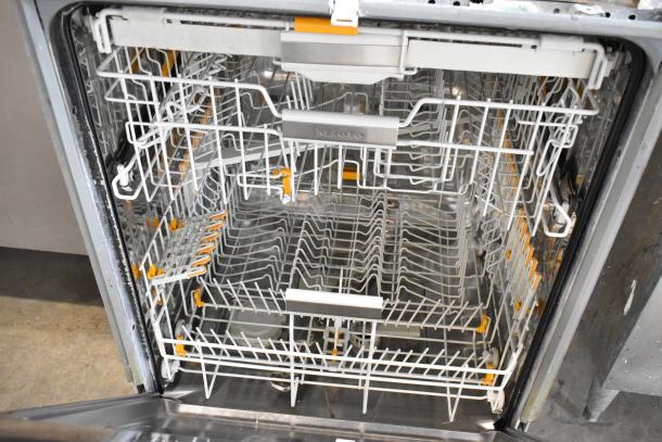 Miele G 6875 SCVi SF dishwasher, stainless steel, open showing racks. Undercounter, 115V, excellent condition.
