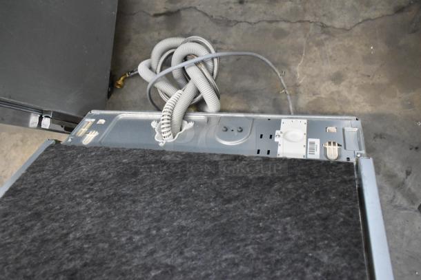 Miele G 6875 SCVi SF dishwasher, stainless steel, 115V, undercounter model shown from the back with hoses visible.