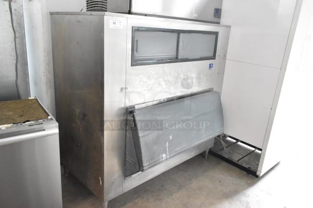 Manitowoc stainless steel commercial ice head on bin, 208-230V, 1 phase. Used condition with exterior wear marks.