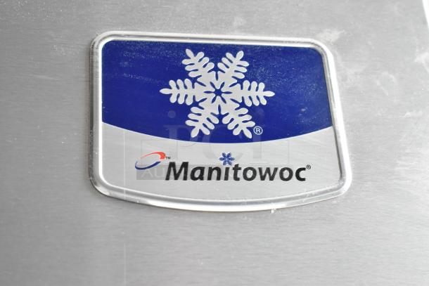 Manitowoc logo on stainless steel commercial ice head, featuring a snowflake design. 208-230 Volts, 1 Phase.