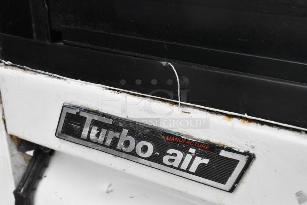 Turbo Air TGM-69R commercial cooler label, visible wear and tear. Model TGM-69R, 115 Volts, 1 Phase.