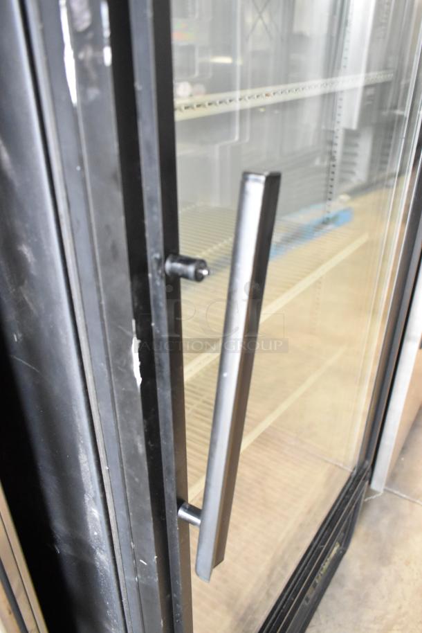 True GDM-26EM commercial cooler, single glass door, metal frame, poly-coated racks, 115V, visible handle, good condition.