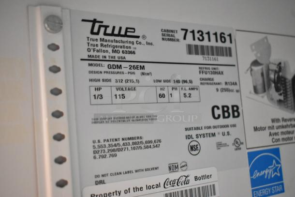 True GDM-26EM commercial cooler label detailing model, voltage, phase, refrigerant, and suitability for outdoor use.