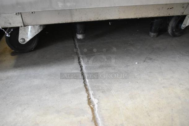 Everest ESRFH2 commercial refrigerator/freezer on casters, stainless steel, showing sturdy commercial wheels on concrete floor.