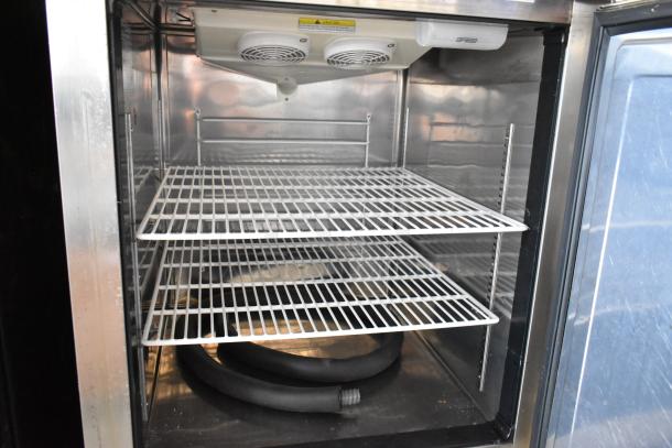 Everest ESRFH2 stainless steel commercial reach-in dual temperature refrigerator/freezer, interior view with shelves and cooling units visible.
