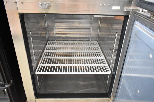 Everest ESRFH2 stainless steel dual temp fridge-freezer, commercial grade, on casters. Interior with wire shelves. 115V, 1 phase.