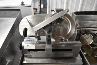 Globe stainless steel commercial countertop meat slicer with blade sharpener; 115 volts, 1 phase; gently used condition.