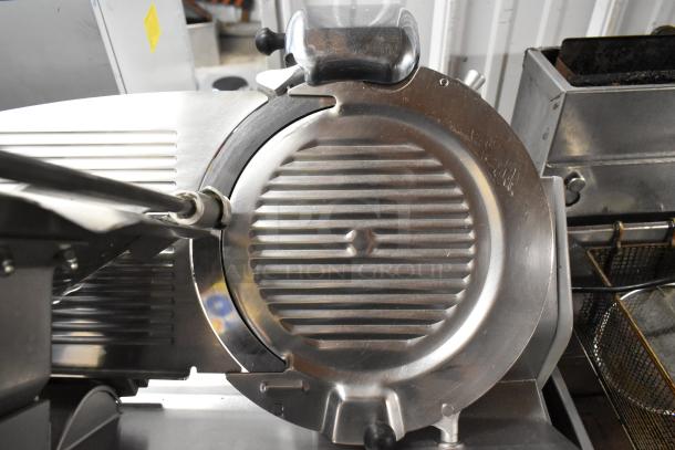 Globe stainless steel commercial countertop meat slicer with blade sharpener, in good condition, 115 volts, 1 phase.