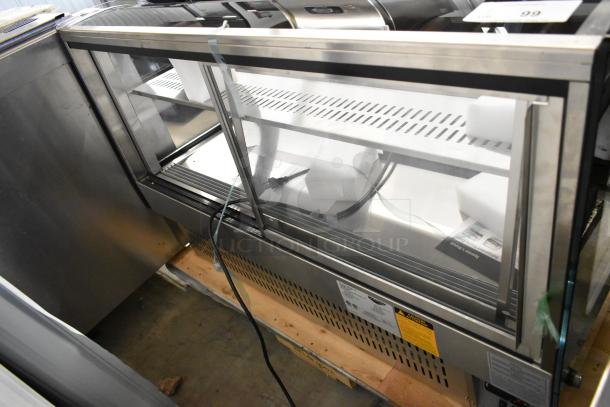 Brand new Vollrath RDE7148 stainless steel refrigerated display case. Features glass front, shelves, 120V, 1 phase. Minor scratches.