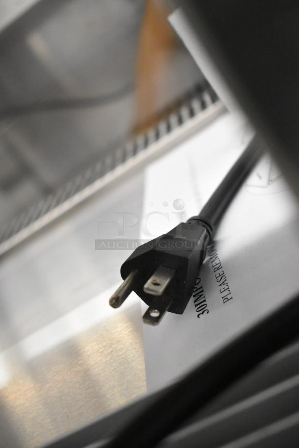 Black power cord for Vollrath RDE7148 display case on stainless steel surface with partially visible label.