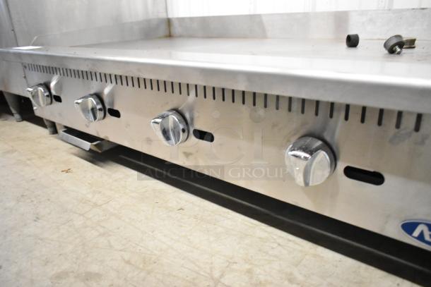Atosa stainless steel commercial countertop gas griddle with four control knobs, clean surface, and visible brand logo.