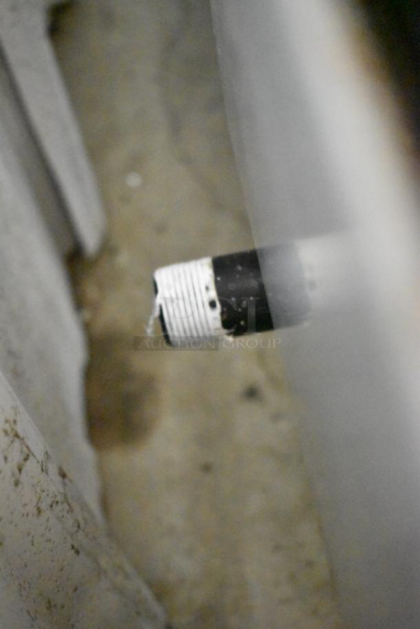 A close-up view of a gas connection pipe, possibly related to the Atosa stainless steel commercial griddle.