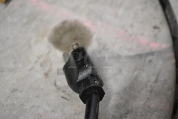 Blurry image of a power plug on a concrete surface, likely for a Hoshizaki HNC-180BA-L-S sushi display case.