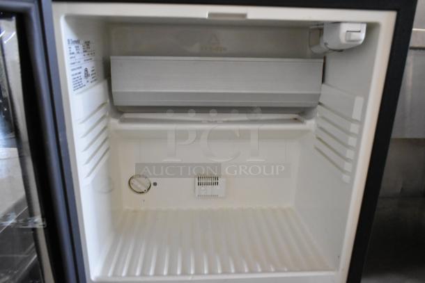 Dometic RH023LDAG metal mini cooler merchandiser, 115 volts, 1 phase, inside view, temperature control knob visible.
