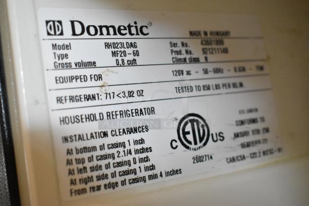 Dometic RH023LDAG mini cooler label showing model, serial number, specifications, and safety certifications. Suitable for 115 volts.