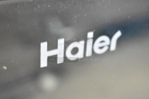 Haier HBCN02EBB metal mini cooler detail, featuring the brand logo. 115V, 1 Phase, merchandiser model.