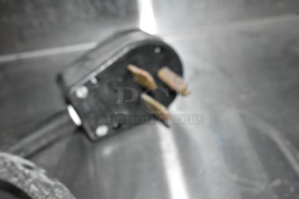 Blurred image of an electrical plug for a Win Depot WBFHT-500 Stainless Steel Steam Table. 208 Volts, 1 Phase.