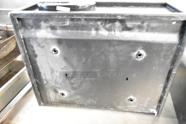 Two black metal single compartment safes without combinations, showing surface wear, ideal for secure storage.