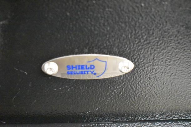 Black metal single compartment safe by Shield Security, no combinations provided, includes "Shield Security" label.