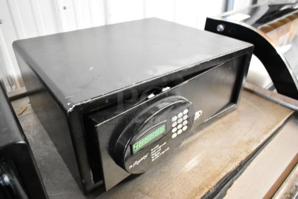 Black metal single compartment safe, electronic keypad, no combination included. Slight surface wear visible.