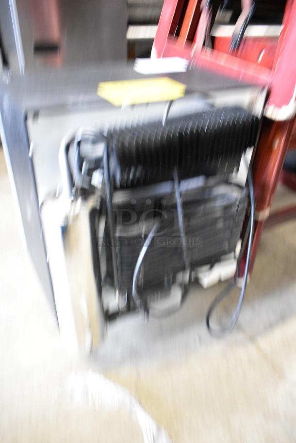 Dometic RH023LDAG metal mini cooler merchandiser, 115 volts, 1 phase, showing exterior and cooling components. Appears used.