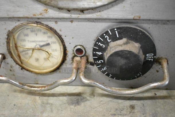 Toastmaster 3ABOA warming drawer control panel with temperature gauge, knob settings 1-5, and visible wear and rust.