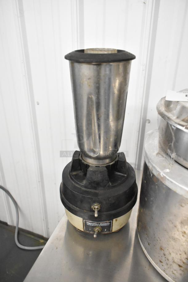 Hamilton Beach blender with a stainless steel body and black base, showing a two-speed toggle. Includes Nemco soup kettle.