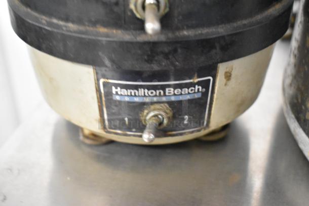 Hamilton Beach Commercial blender base with power switches, slight wear. Ideal for kitchen use.