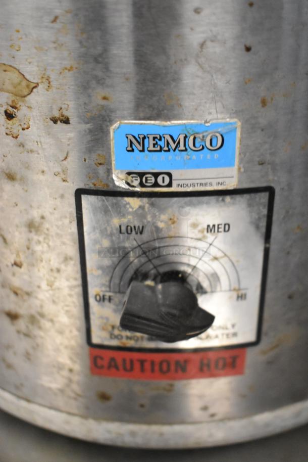 Nemco countertop soup kettle with settings dial; visible wear and dirt. Caution: hot. Includes Hamilton Beach blender.