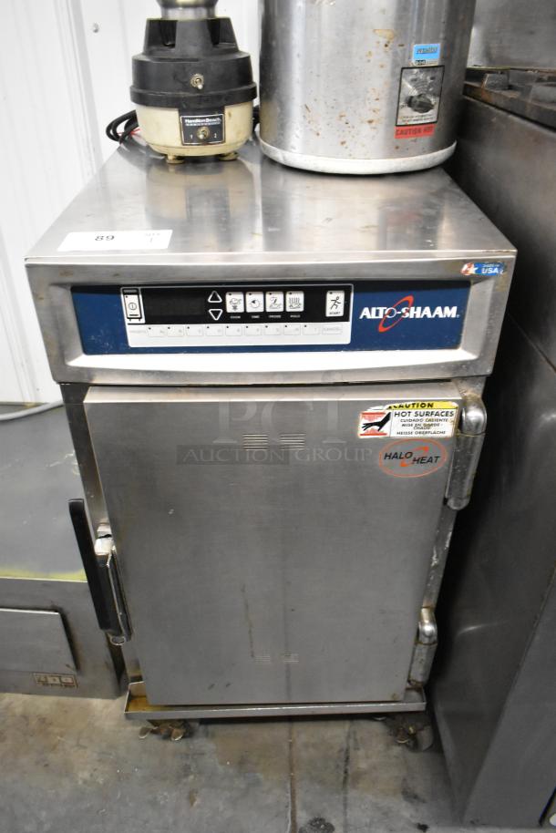 Alto Shaam 500-TH/III Halo Heat cook and hold cabinet, stainless steel, on commercial casters, showing control panel and caution label.