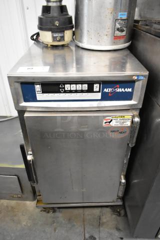 Alto Shaam 500-TH/III Halo Heat cook and hold cabinet, stainless steel, on commercial casters, showing control panel and caution label.