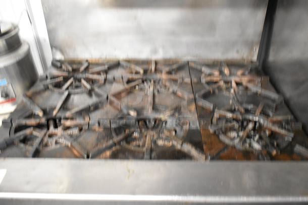 Garland Stainless Steel 6 Burner Range, natural gas, with oven, salamander cheese melter, and backsplash. Used condition.
