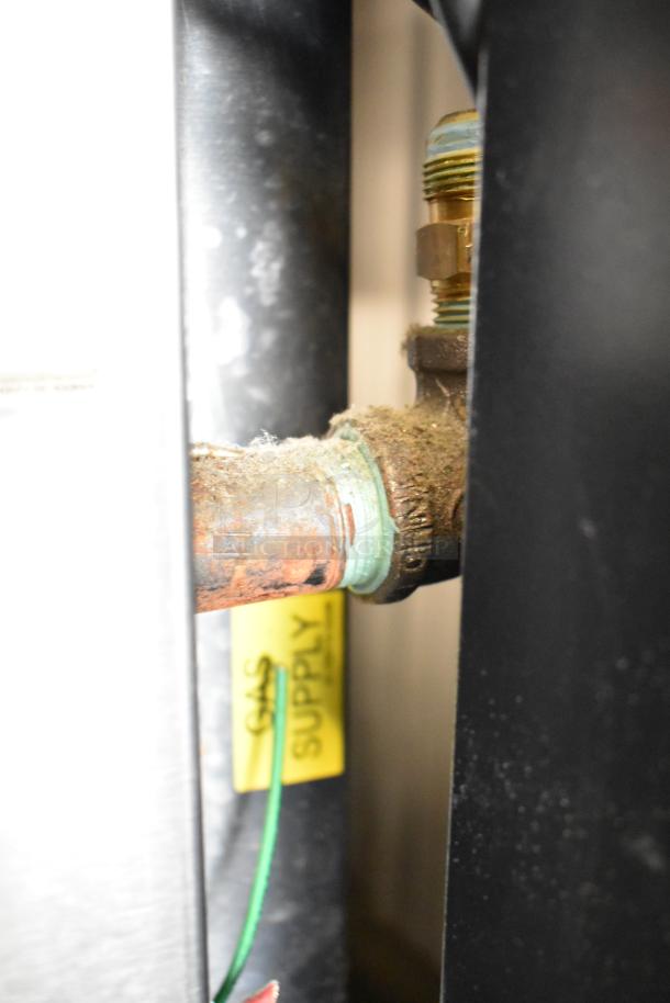Baxter OV310G oven gas connection detail, shows supply line with visible corrosion and "GAS SUPPLY" label.