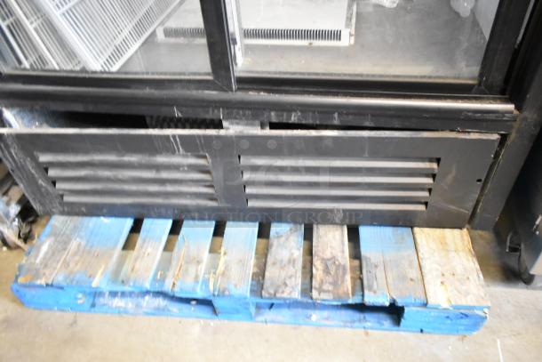 QBD CD45-HC metal commercial 2-door cooler on a pallet, features poly-coated racks, 115V, 1 phase, visible wear on vents.