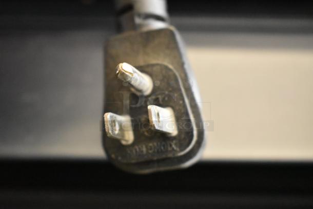 Close-up of a power plug for a QBD CD45-HC commercial cooler, showing its three-prong configuration.