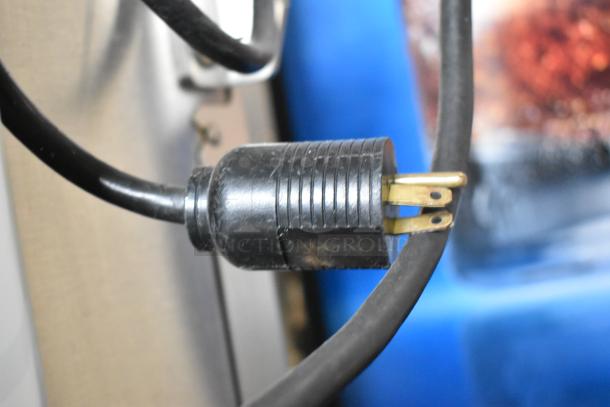 Close-up of the power plug for the Fresh N Squeeze 2ND-GEN-MFJ-HE citrus juicer, showing a standard three-prong plug.