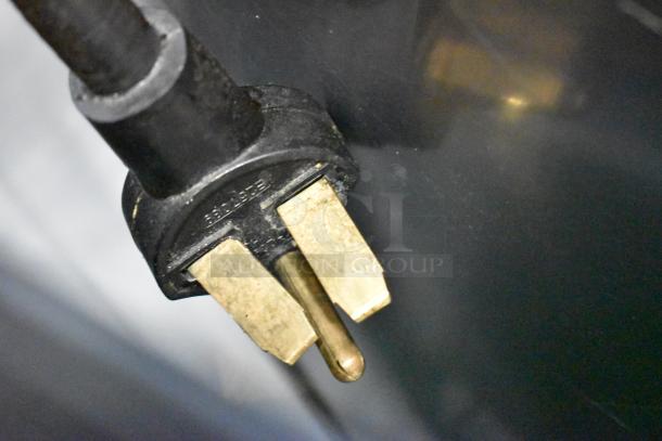 Power plug of Turbochef i5 rapid cook oven. Features brass prongs, compatible with 208/240V, 1 phase electric supply.