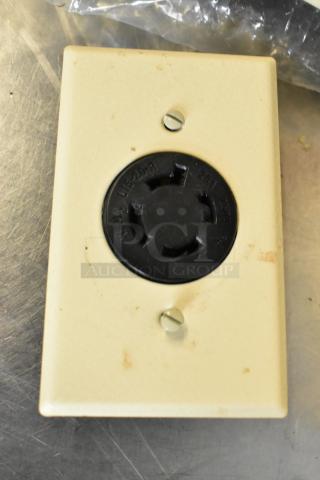 Beige electrical outlet cover with a black NEMA L6-20R outlet, showing wear. Features 14 outlets, enhancing appeal.