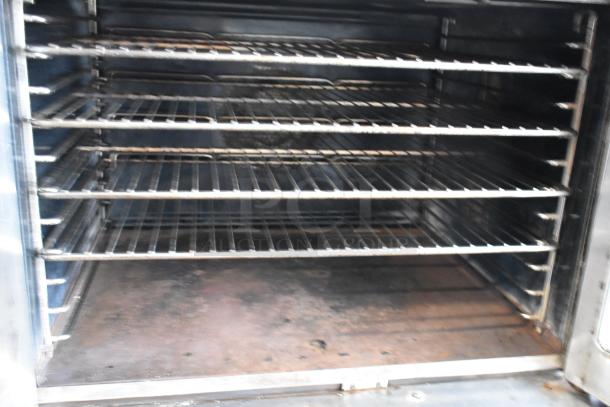 Bakers Pride stainless steel commercial gas convection oven with view-through doors, metal racks, and thermostatic controls.